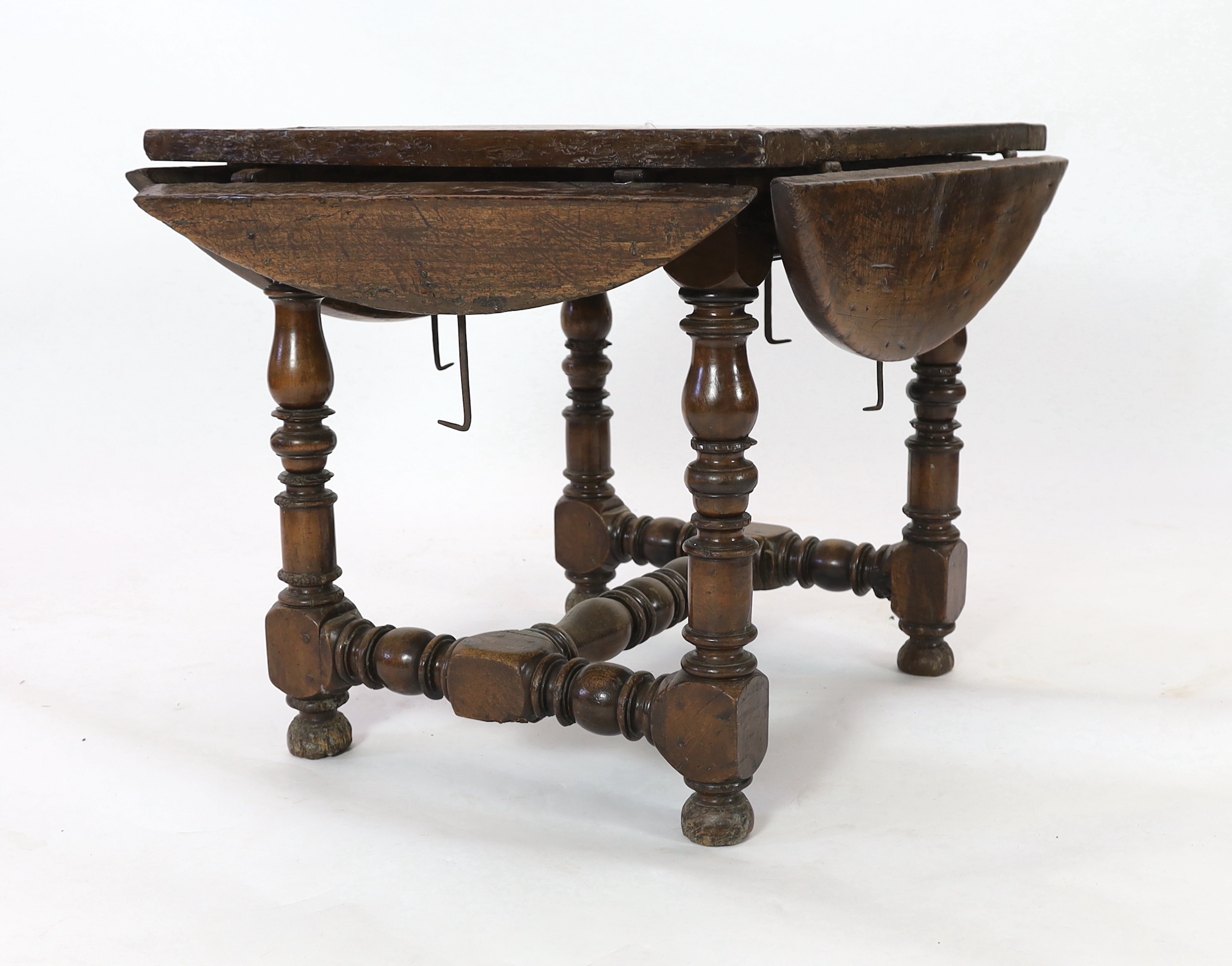 A late 17th century Spanish walnut dining table, 100 x 83cm with flaps down